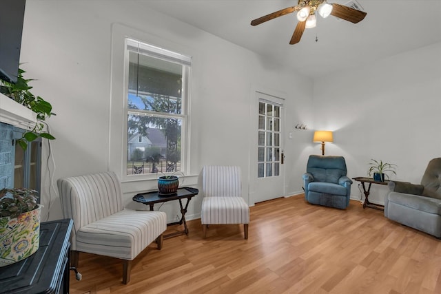 1710 Mckenzie Ave, Waco, TX 76708 - living area featuring light wood-type flooring, a ceiling fan, a fireplace, and baseboards