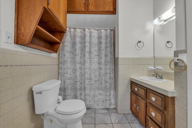 1710 Mckenzie Ave, Waco, TX 76708 - bathroom with tile walls, vanity, toilet, wainscoting, and marble look tile flooring