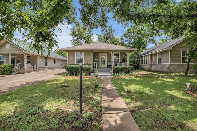 1710 Mckenzie Ave, Waco, TX 76708 - view of front facade with covered porch, a front yard, and a chimney