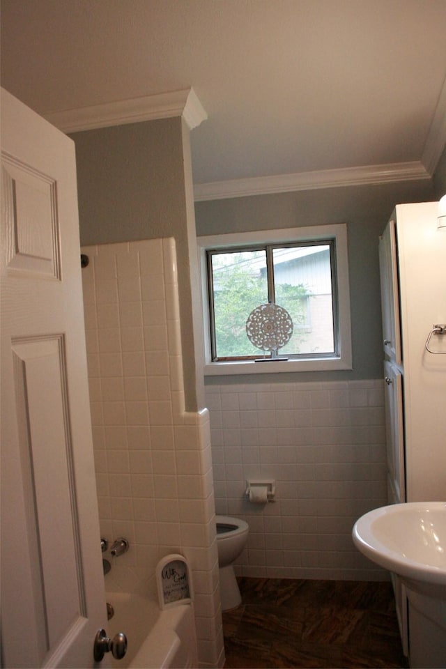 8514 Elmview Pl, Shreveport, LA 71108 - bathroom featuring toilet, crown molding, tile walls, shower / bath combination, and a wainscoted wall