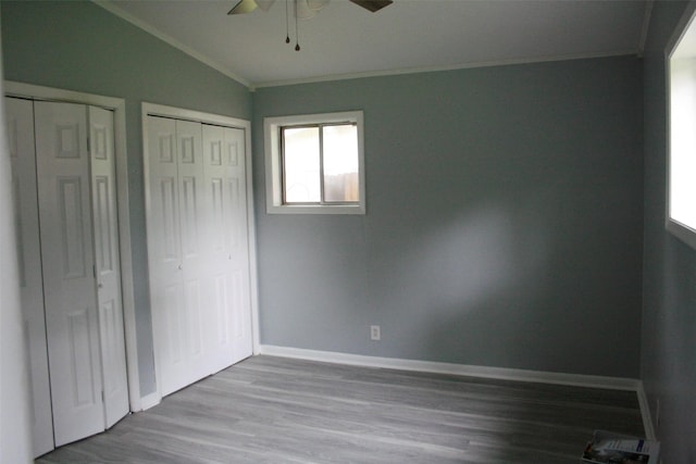 8514 Elmview Pl, Shreveport, LA 71108 - unfurnished bedroom with crown molding, vaulted ceiling, wood finished floors, multiple closets, and baseboards