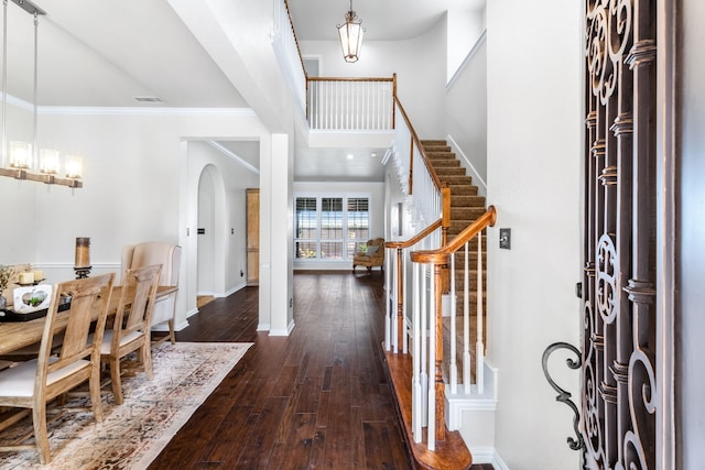 5820 Lakeland Ct, Sachse, TX 75048 - foyer entrance featuring stairway, wood-type flooring, ornamental molding, baseboards, and arched walkways