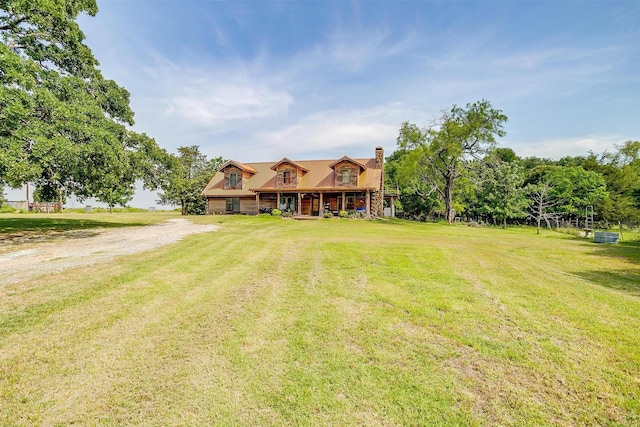 view of front of property featuring a front lawn and a chimney
