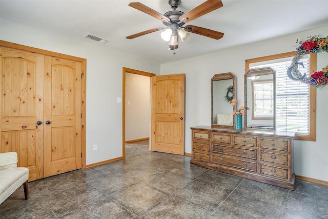 bedroom with baseboards, a closet, and a ceiling fan