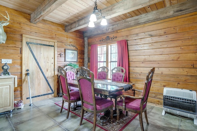 dining room featuring heating unit, wood ceiling with exposed beams, wood walls, and concrete flooring