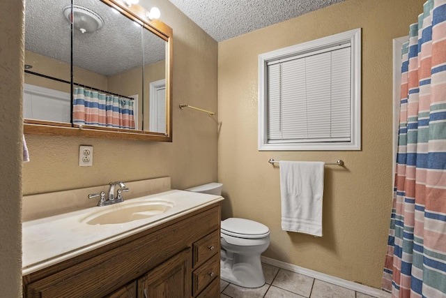 201 S Caney St, Dodd City, TX 75438 - full bath with tile patterned floors, vanity, toilet, a textured ceiling, and a shower with shower curtain