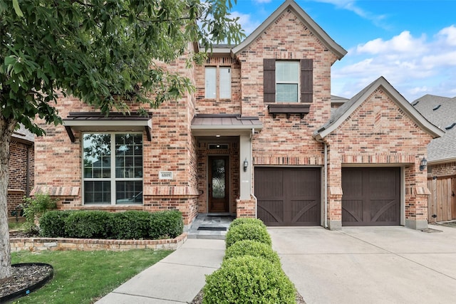 6809 Gallatin St, Mckinney, TX 75070 - view of front of property featuring brick siding, driveway, an attached garage, and a standing seam roof