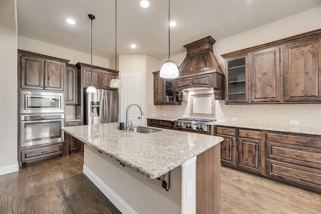 6809 Gallatin St, Mckinney, TX 75070 - kitchen featuring appliances with stainless steel finishes, a sink, tasteful backsplash, dark brown cabinets, and dark wood-style floors