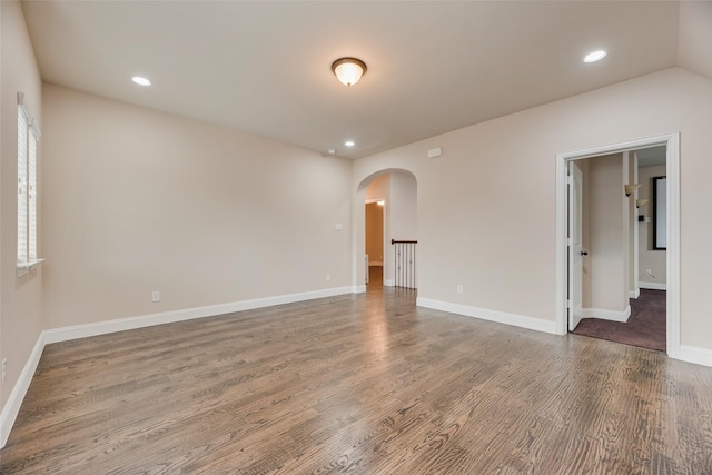 6809 Gallatin St, Mckinney, TX 75070 - spare room with arched walkways, wood finished floors, baseboards, and recessed lighting