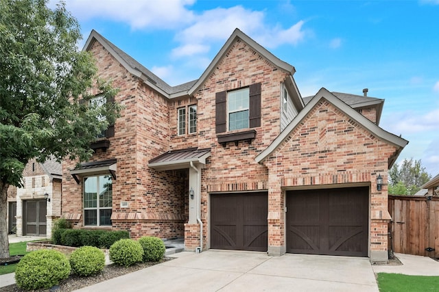 6809 Gallatin St, Mckinney, TX 75070 - view of front of house featuring driveway, brick siding, a garage, and a standing seam roof