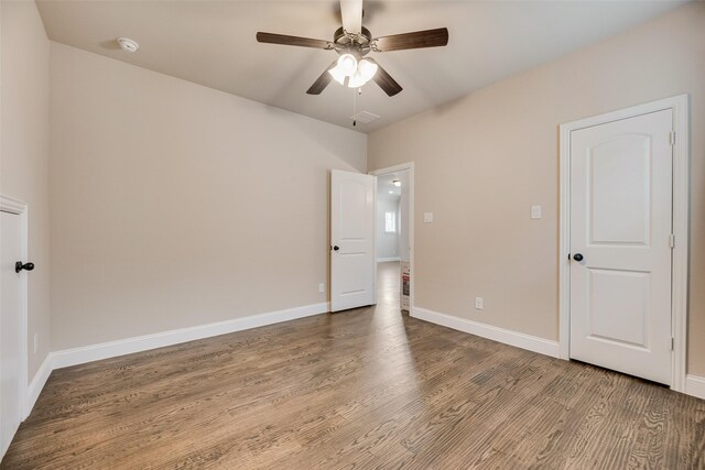 6809 Gallatin St, Mckinney, TX 75070 - unfurnished bedroom featuring wood finished floors, baseboards, and ceiling fan