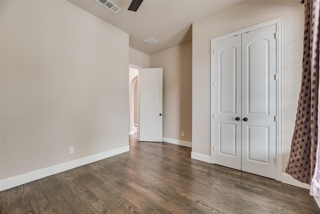 6809 Gallatin St, Mckinney, TX 75070 - unfurnished bedroom with a closet, dark wood-style floors, baseboards, ceiling fan, and arched walkways