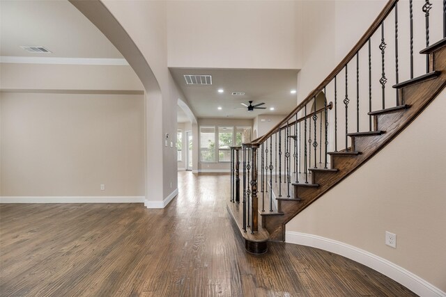 6809 Gallatin St, Mckinney, TX 75070 - foyer entrance with baseboards, a ceiling fan, wood finished floors, arched walkways, and crown molding