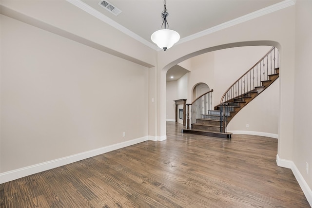 6809 Gallatin St, Mckinney, TX 75070 - entrance foyer featuring arched walkways, ornamental molding, baseboards, wood finished floors, and stairway