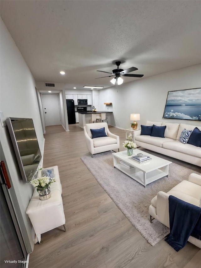 4859 Cedar Springs Rd Unit 150, Dallas, TX 75219 - living area with light wood-style floors, a ceiling fan, and recessed lighting