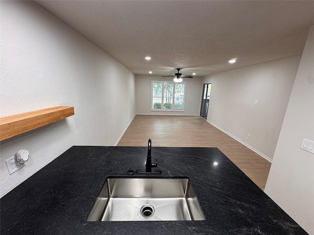 4859 Cedar Springs Rd Unit 150, Dallas, TX 75219 - kitchen featuring a sink, ceiling fan, wood finished floors, recessed lighting, and open floor plan