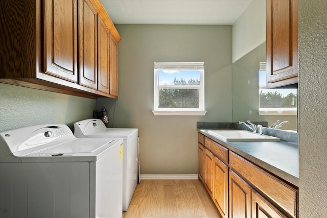 208 Burtonwood Cir, Ovilla, TX 75154 - laundry room with washing machine and dryer, light wood finished floors, cabinet space, and baseboards