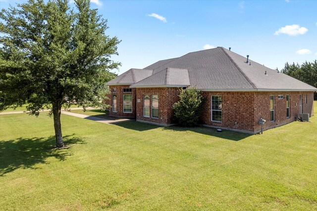 208 Burtonwood Cir, Ovilla, TX 75154 - rear view of property featuring a lawn, brick siding, a shingled roof, and central air condition unit