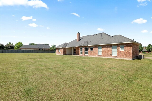 208 Burtonwood Cir, Ovilla, TX 75154 - rear view of property with brick siding, central air condition unit, and a chimney