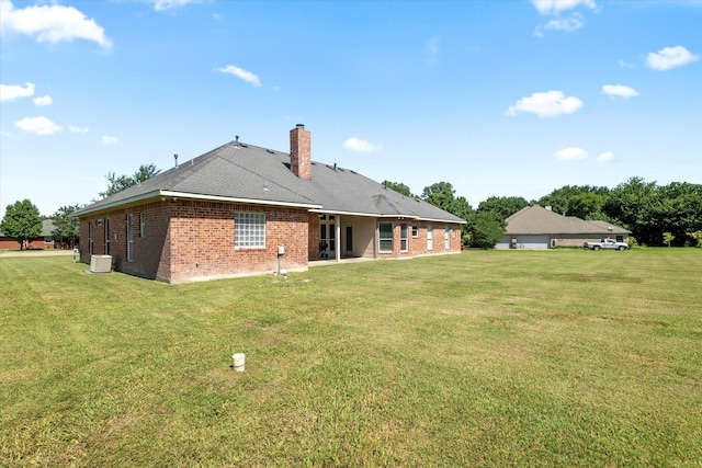 208 Burtonwood Cir, Ovilla, TX 75154 - back of house featuring brick siding, a lawn, and a chimney