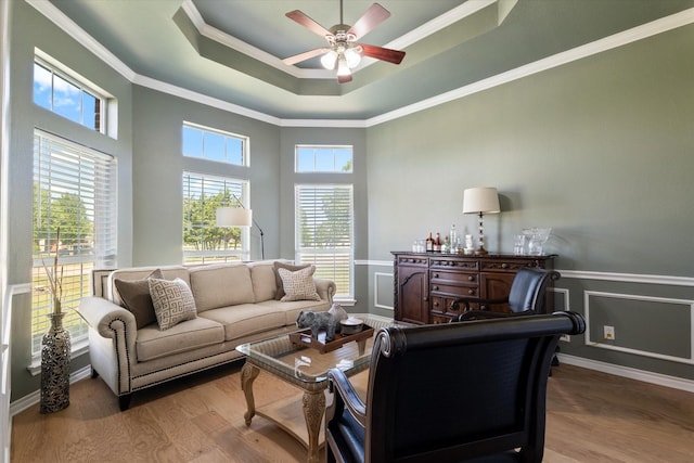 208 Burtonwood Cir, Ovilla, TX 75154 - living area with a ceiling fan, a tray ceiling, wood finished floors, a wainscoted wall, and crown molding