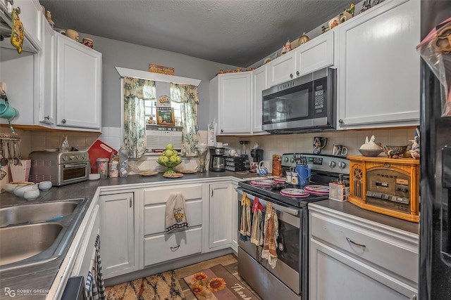 371 Lakeview Dr, Doyline, LA 71023 - kitchen featuring stainless steel appliances, tasteful backsplash, white cabinetry, a sink, and a textured ceiling