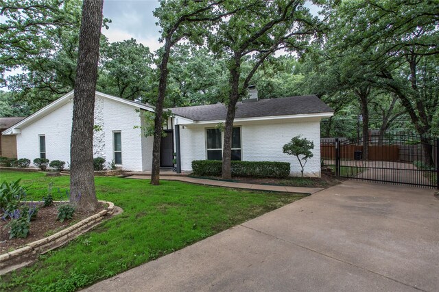 3420 Hampshire Dr, Arlington, TX 76013 - mid-century home featuring a gate, brick siding, a chimney, and concrete driveway