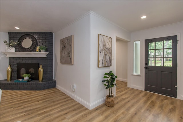 3420 Hampshire Dr, Arlington, TX 76013 - foyer featuring wood finished floors, crown molding, baseboards, recessed lighting, and a fireplace