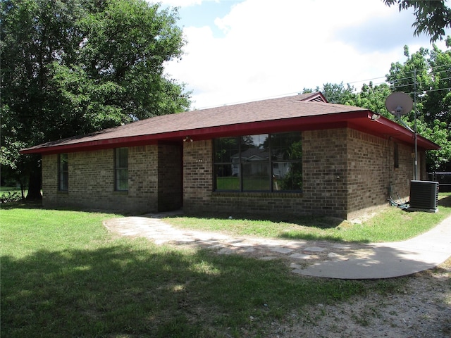 261 Airport Rd, Emory, TX 75440 - view of front of property with brick siding, a front yard, and central AC unit