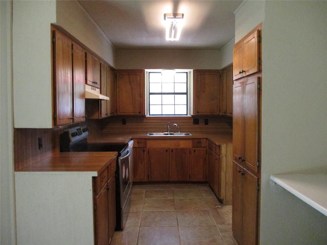 261 Airport Rd, Emory, TX 75440 - kitchen featuring electric stove, under cabinet range hood, brown cabinetry, a sink, and light tile patterned flooring