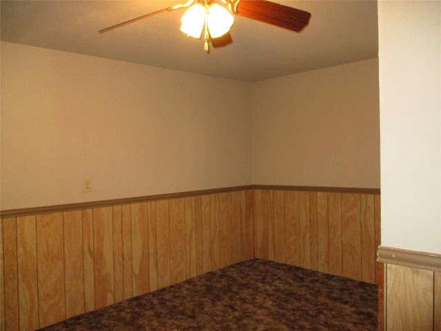 261 Airport Rd, Emory, TX 75440 - carpeted spare room with ceiling fan, wood walls, and a wainscoted wall