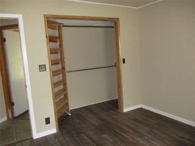 261 Airport Rd, Emory, TX 75440 - unfurnished bedroom with dark wood finished floors, baseboards, crown molding, and a closet