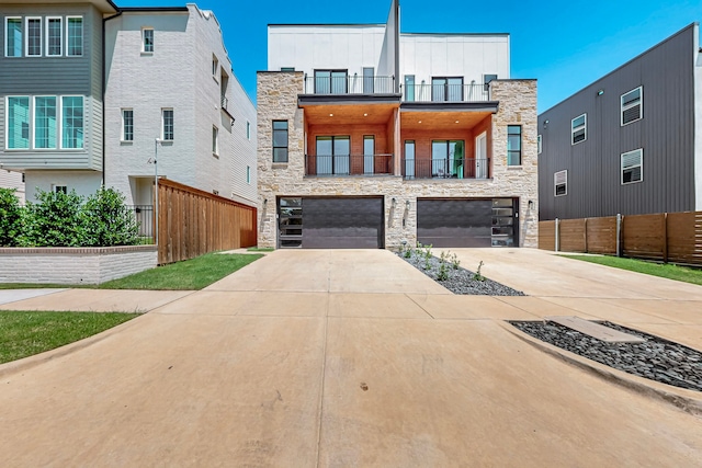 1021 Mobile St, Dallas, TX 75208 - back of property with stone siding, driveway, a garage, board and batten siding, and a balcony