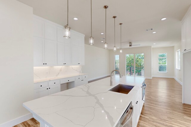 1021 Mobile St, Dallas, TX 75208 - kitchen featuring a sink, light wood-type flooring, stainless steel dishwasher, white cabinets, and recessed lighting