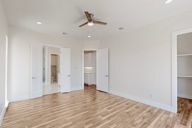 1021 Mobile St, Dallas, TX 75208 - unfurnished bedroom with a spacious closet, light wood-style floors, recessed lighting, and baseboards