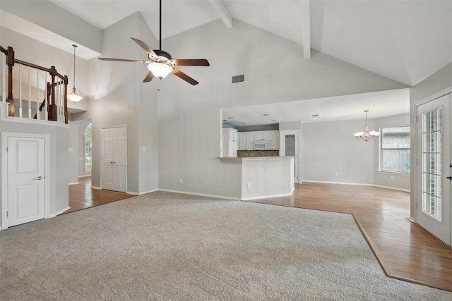 9228 Winslow Ct, North Richland Hills, TX 76182 - unfurnished living room featuring high vaulted ceiling, a chandelier, wood finished floors, plenty of natural light, and a ceiling fan