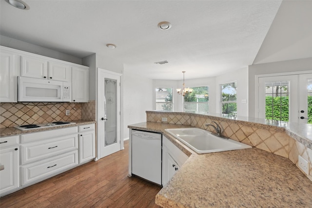 9228 Winslow Ct, North Richland Hills, TX 76182 - kitchen featuring white appliances, a sink, dark wood finished floors, decorative backsplash, and healthy amount of natural light