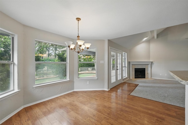 9228 Winslow Ct, North Richland Hills, TX 76182 - unfurnished living room featuring plenty of natural light, baseboards, a chandelier, a tiled fireplace, and vaulted ceiling