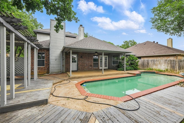 9228 Winslow Ct, North Richland Hills, TX 76182 - view of swimming pool with a wooden deck, a pergola, a patio, and french doors