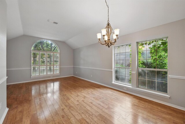 9228 Winslow Ct, North Richland Hills, TX 76182 - unfurnished room featuring hardwood / wood-style floors, lofted ceiling, a chandelier, and baseboards
