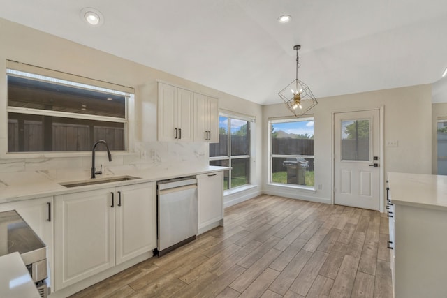 11417 Harbor Rd, Frisco, TX 75035 - kitchen featuring stainless steel dishwasher, a sink, decorative backsplash, light countertops, and light wood-style flooring
