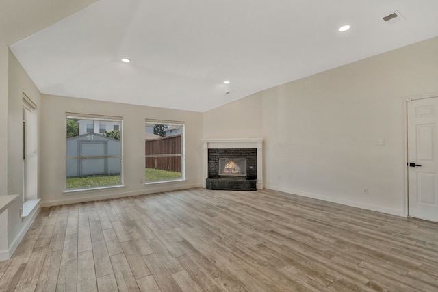 11417 Harbor Rd, Frisco, TX 75035 - unfurnished living room featuring vaulted ceiling, light wood finished floors, a fireplace, recessed lighting, and baseboards