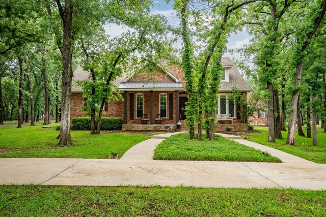 306 Stonecrest Rd, Argyle, TX 76226 - view of front of property featuring a front lawn, covered porch, and brick siding