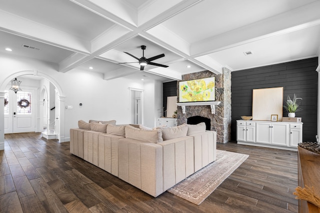 306 Stonecrest Rd, Argyle, TX 76226 - living room with arched walkways, dark wood-type flooring, a ceiling fan, beam ceiling, and a fireplace