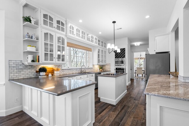 306 Stonecrest Rd, Argyle, TX 76226 - kitchen with a chandelier, open shelves, stainless steel appliances, white cabinetry, and recessed lighting