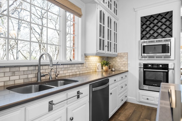 306 Stonecrest Rd, Argyle, TX 76226 - kitchen with appliances with stainless steel finishes, a sink, glass insert cabinets, and decorative backsplash