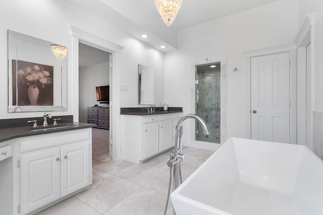 306 Stonecrest Rd, Argyle, TX 76226 - bathroom with a stall shower, recessed lighting, two vanities, a freestanding bath, and a chandelier