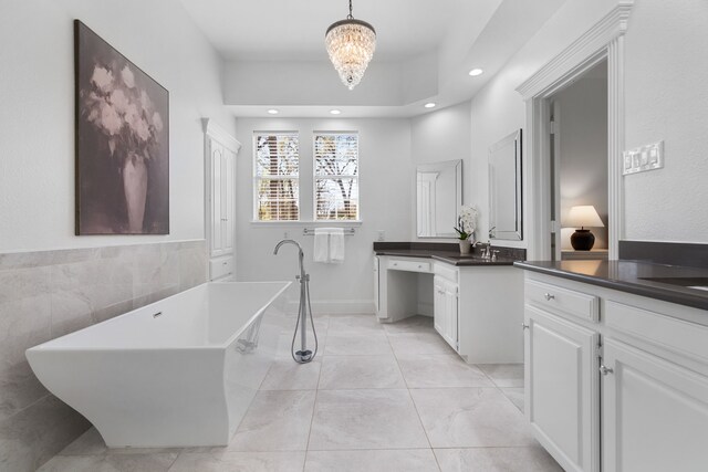 306 Stonecrest Rd, Argyle, TX 76226 - bathroom featuring vanity, a soaking tub, recessed lighting, a chandelier, and tile walls