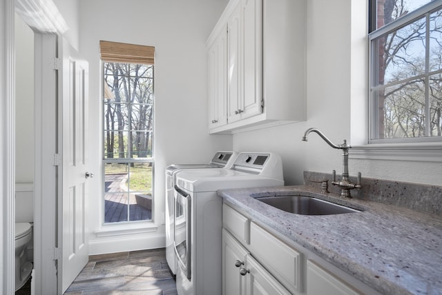 306 Stonecrest Rd, Argyle, TX 76226 - laundry room with independent washer and dryer, cabinet space, wood finished floors, and baseboards