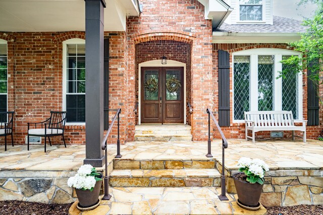 306 Stonecrest Rd, Argyle, TX 76226 - view of exterior entry with french doors and brick siding